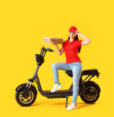 Fototapeta na wymiar Female courier with scooter and tasty pizza on yellow background
