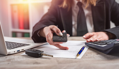 female car dealer explaining the conditions purchase or rent car at office