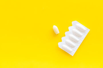 Rectal suppositories in white blister, top view. Pharmaceuticals for medical treatment
