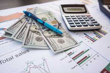 Annual report financial charts with pen, calculator and dollar