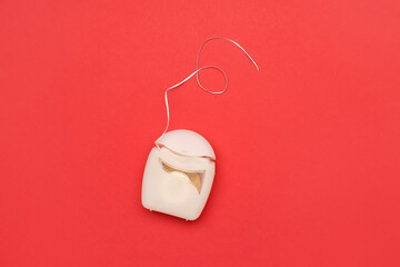 Dental floss on red background