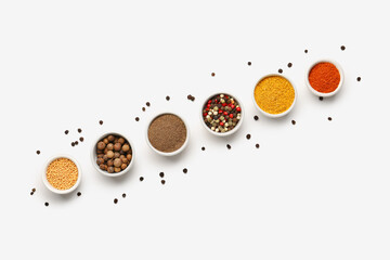 Composition with bowls of fresh aromatic spices on light background
