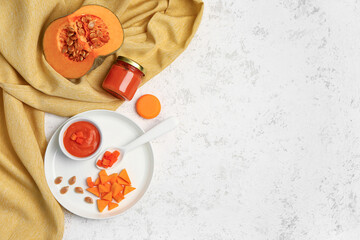 Composition with healthy baby puree and fresh pumpkin on light background