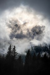 Fototapeta na wymiar Dramatic ambiance of white clouds over the Gantrisch Mountain in Swiss Alps