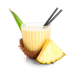 Glass of tasty pineapple smoothie with straw in coconut shell on white background