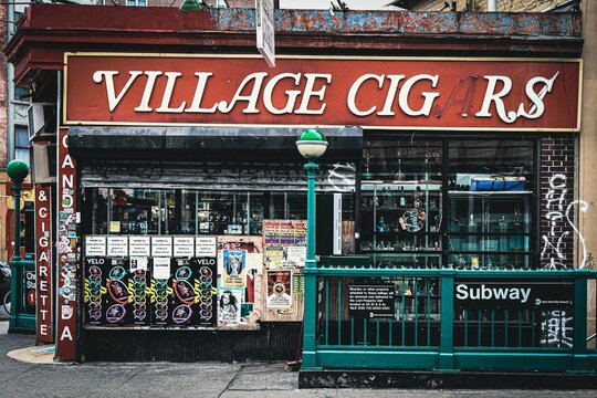 Village Cigar shop with colorful posters at the New York City subway