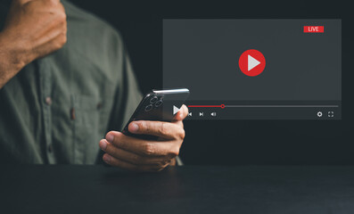Experience the power of a smartphone for live streaming, with a man engrossed in video content on the screen. Discover the seamless integration of technology and media in today's connected lifestyle.