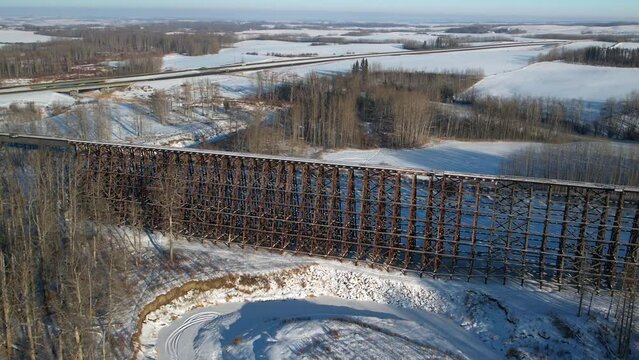 Aerial footage of the Rochfort Trestle Bridge in Alberta, Canada in winter