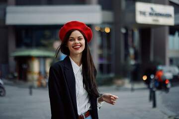 Woman smile with teeth tourist walks walks in the city on the background of office buildings, stylish fashionable clothes and make-up, spring walk, travel.