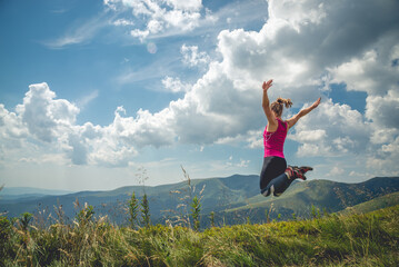 Fototapeta premium Young woman on the top of mountain