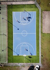 Aerial view over blue basketball court in the garden