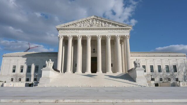 Facade Of The Supreme Court Of The United States Against The Sunny Blue Sky In Washington DC