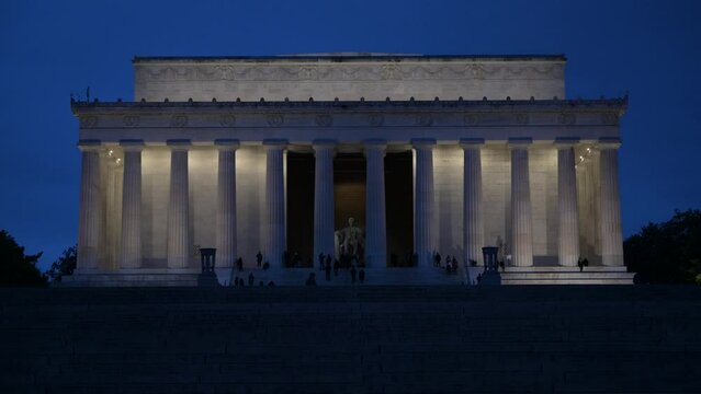 Visitors at the illuminated Abraham Lincoln Memorial during the nighttime in Washington DC
