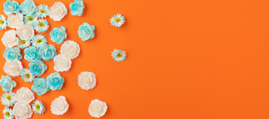 Blue and White Bed Flowers with orange copy space flat lay