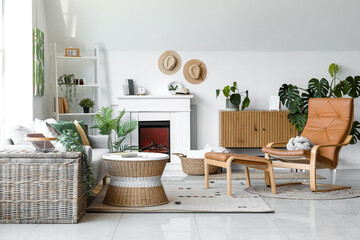 Interior of cozy living room with sofa, armchair and fireplace