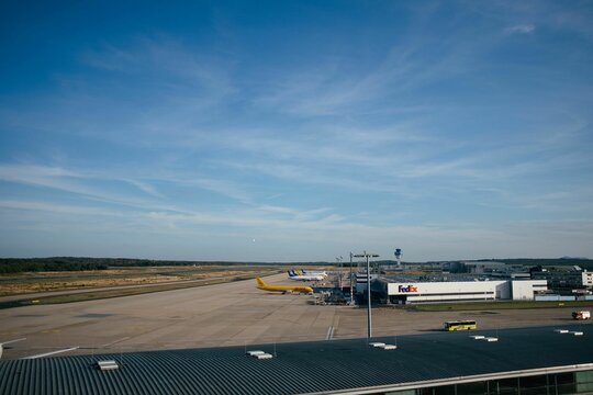 Cologne Bonn Airport under a blue sky. Fedex and DHL aircraft are ready for air transport