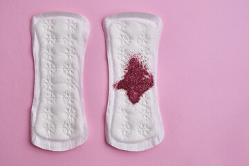 Menstrual pad with red sequins on a pink background. The period of the menstrual cycle, feminine hygiene. Women's health concept
