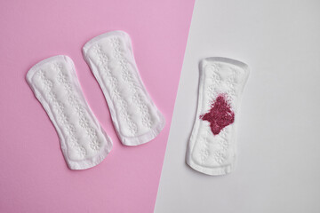 Menstrual pad with red sequins on a pink background. The period of the menstrual cycle, feminine hygiene. Women's health concept