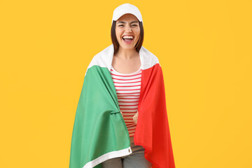 Young woman with flag of Italy on yellow background