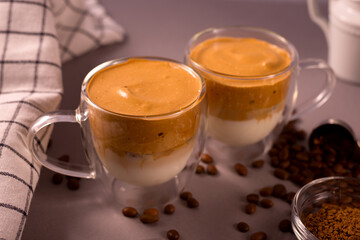 Transparent double wall glass mug with Dalgona Coffee. Whipped icing drink with instant coffee popular Creamy cocktail.