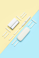 Composition with modern electronic cigar and sticks on colorful background