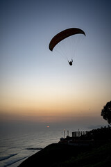 Paragliding during the Sunset in la Costa Verde (Green Coast) in Lima, Peru - 612531956