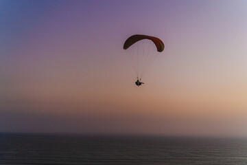 Paragliding during the Sunset in la Costa Verde (Green Coast) in Lima, Peru - 612531988
