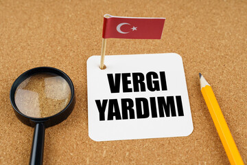 On the table is the flag of Turkey, a pencil and a sheet of paper with the inscription - TAX Help