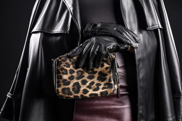 Stylish young woman in leather gloves with bag on dark background, closeup © Pixel-Shot