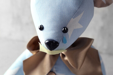 Toy bear with taped mouth and paper tear on grunge background, closeup. Domestic violence concept