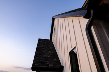 new construction white house with black trim with blue sky