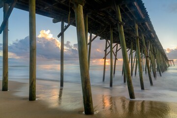 Scenic view of Kure Beach pier during colorful sunrise, long exposure