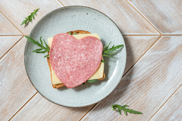 Heart shape sandwich with salami and cheese