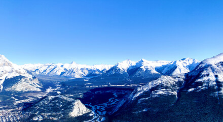 Fototapeta na wymiar Aerial view of the snow covered mountain peaks of Banff National park in Alberta, Canada