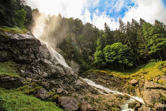 Breathtaking view of the Lares Waterfall in Pinzolo on a sunny day