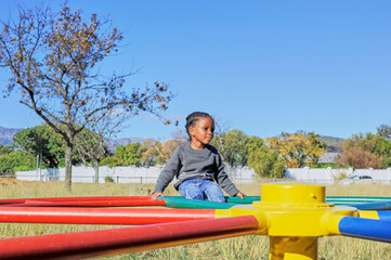 black child playing on a swing 
