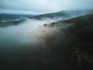 Aerial shot of the misty Serra de Caldeirao Mountain range in Portugal