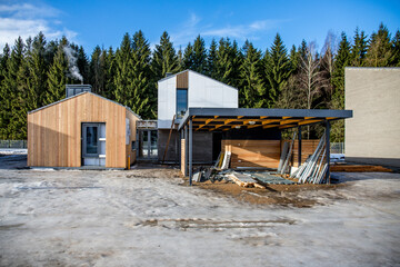 Image of Unfinished scandinavian style wooden house and parking