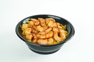 Closeup of the black pasta bowl with cajun shrimp and rice skillet isolated on white background