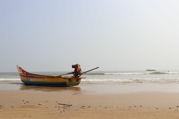 Old colorful boat on a sandy beach.