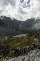 Fototapeta premium Vertical shot of the valley with a lake surrounded by mountains.
