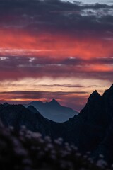 Silhouette mountains under colorful sky during sunset
