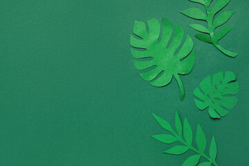Beautiful origami leaves on green background