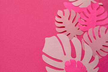 Fototapeta na wymiar Beautiful origami leaves on pink background, closeup