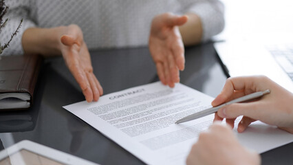 Businesswoman lawyer pointing into contract special points admitting something for colleague or client at meeting. Business people teamwork and partnership.