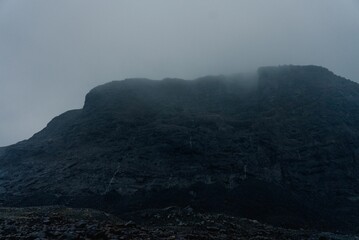 Dark cliff on a foggy day.