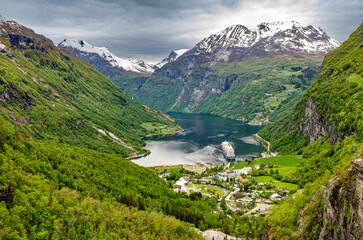 Fototapeta na wymiar Beautiful fjord Geiranger waterway in Norway. Important travel channel for boats and cruise ships to get to cities through beautiful nature. 