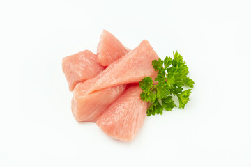 Raw pieces of turkey meat with greens on a white background.Fresh frozen pieces of turkey meat on a white background.Raw chicken. chicken fillet.Ogranic food and healthy eating.turkey or poultry meat.