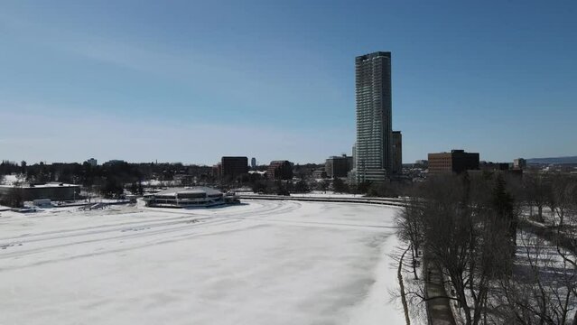 Aerial of the frozen Dow's Lake with the Ottawa snowy cityscape on a sunny winter day