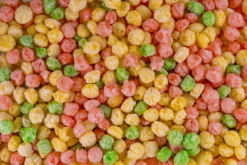 Cereal colored balls. Breakfast food. flat lay, top view. Delicious and nutritious fruit cereal loops flavorful, healthy and funny addition to kids breakfast